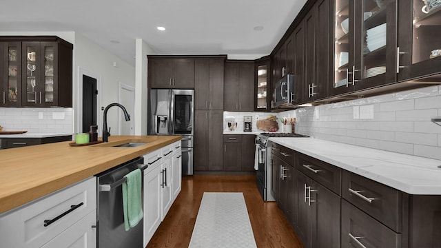 1098 Oregon Ave, Columbus, OH 43201 - kitchen featuring stainless steel appliances, dark brown cabinets, butcher block countertops, backsplash, and recessed lighting