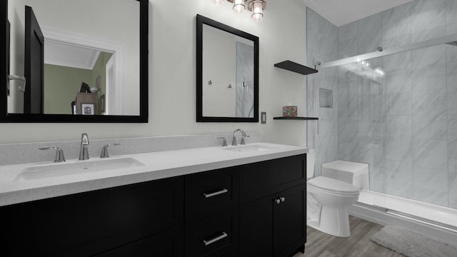 1098 Oregon Ave, Columbus, OH 43201 - bathroom with double vanity, tiled shower, and wood finished floors