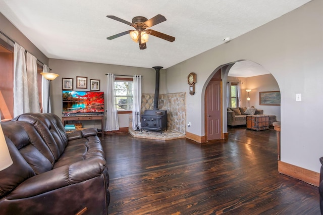 2380 Cedar Hill Rd SW, Amanda, OH 43102 - living area featuring wood finished floors, ceiling fan, a wood stove, and arched walkways