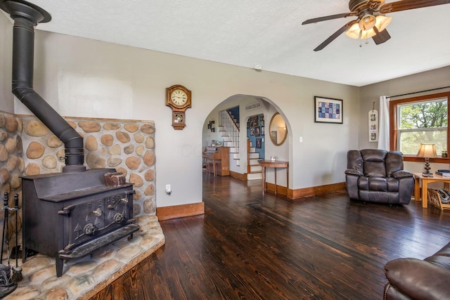 2380 Cedar Hill Rd SW, Amanda, OH 43102 - living area featuring hardwood / wood-style flooring, a wood stove, ceiling fan, arched walkways, and stairs