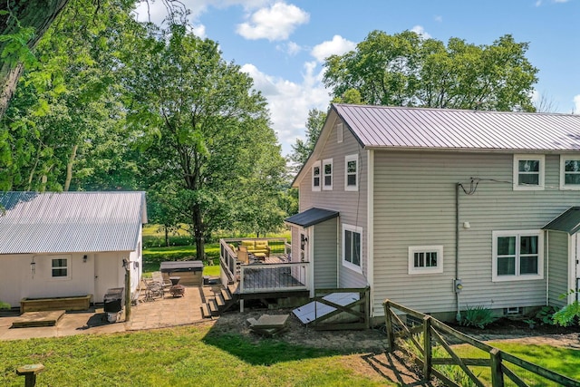 2380 Cedar Hill Rd SW, Amanda, OH 43102 - back of property featuring a deck, a patio, a hot tub, and a metal roof