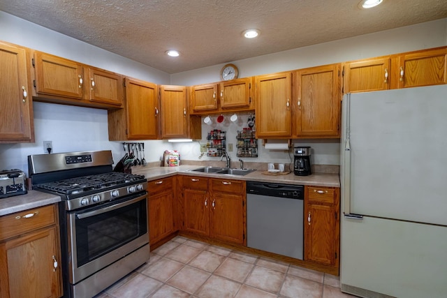 591 Knights Ave, Columbus, OH 43230 - kitchen featuring stainless steel appliances, light countertops, brown cabinets, recessed lighting, and a textured ceiling