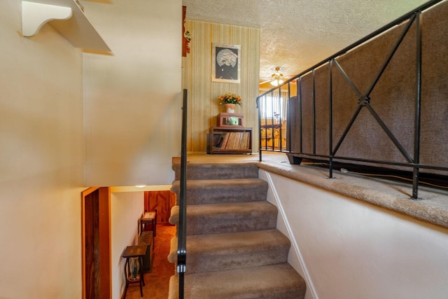 591 Knights Ave, Columbus, OH 43230 - stairway featuring carpet floors, a textured ceiling, and ceiling fan