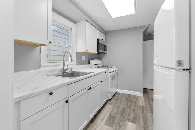 334 S Richardson Ave, Columbus, OH 43204 - kitchen with white appliances, white cabinetry, light wood-type flooring, and a paneled ceiling
