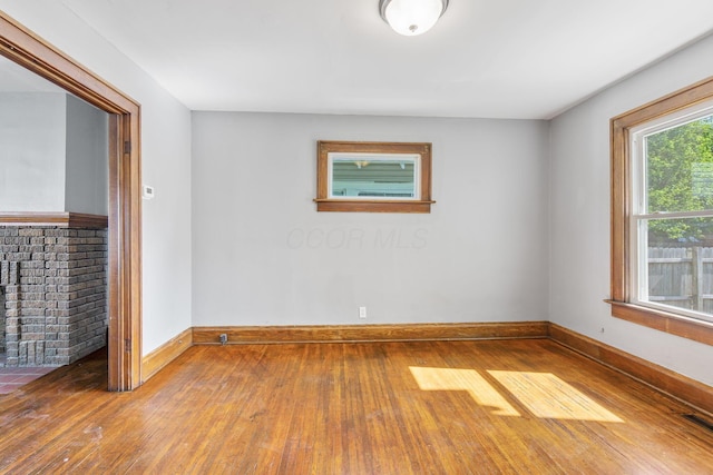 334 S Richardson Ave, Columbus, OH 43204 - empty room featuring wood-type flooring and a brick fireplace