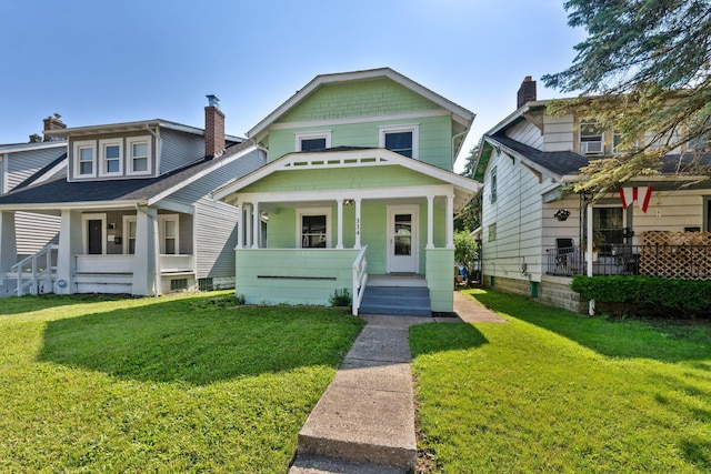 334 S Richardson Ave, Columbus, OH 43204 - view of front of property featuring covered porch, a front lawn, and a chimney