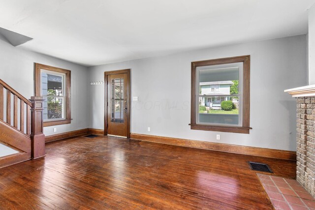 334 S Richardson Ave, Columbus, OH 43204 - unfurnished living room with plenty of natural light, hardwood / wood-style flooring, stairs, and a fireplace