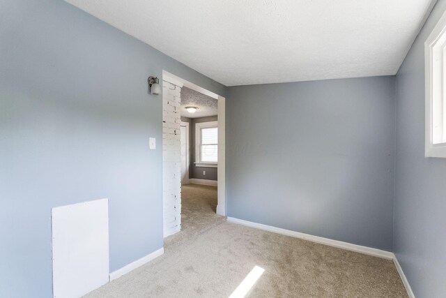 334 S Richardson Ave, Columbus, OH 43204 - carpeted spare room featuring baseboards and a textured ceiling