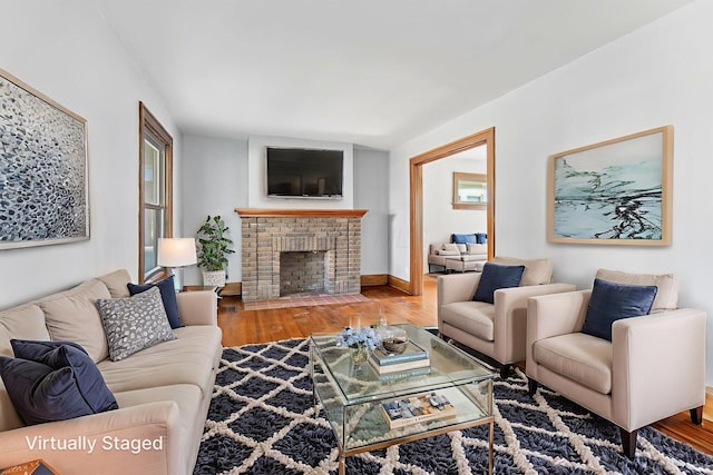 334 S Richardson Ave, Columbus, OH 43204 - living area featuring wood finished floors and a brick fireplace
