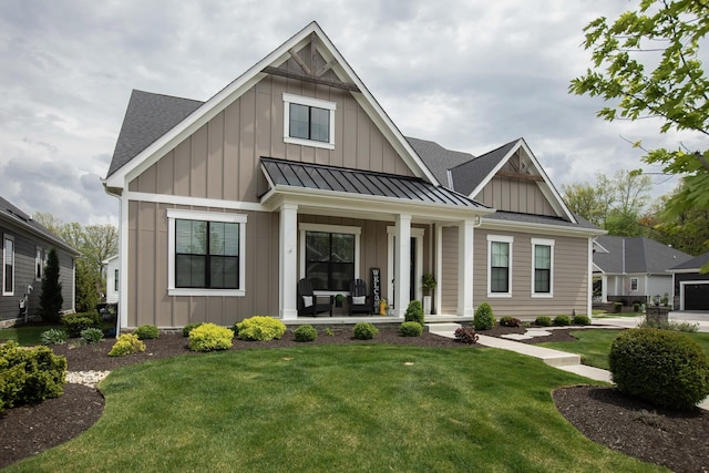 8210 Lilium Way, Plain City, OH 43064 - view of front of property with a porch, board and batten siding, a standing seam roof, and a front yard
