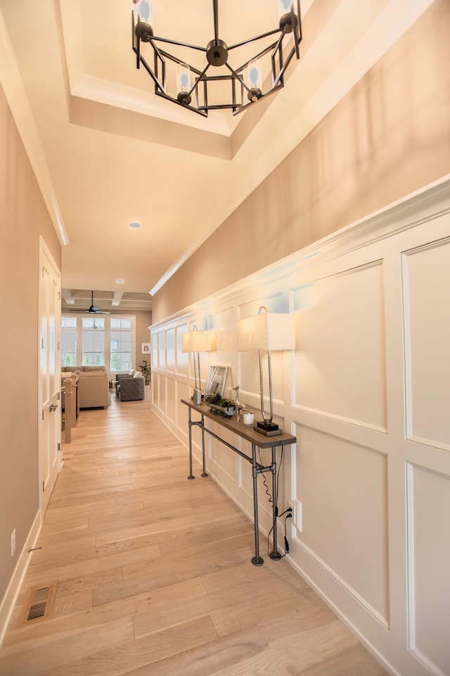 8210 Lilium Way, Plain City, OH 43064 - hallway with a chandelier, ornamental molding, french doors, a decorative wall, and light wood-style flooring