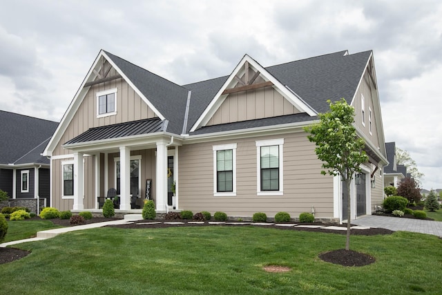 8210 Lilium Way, Plain City, OH 43064 - view of front of home featuring board and batten siding, covered porch, a front yard, and a shingled roof