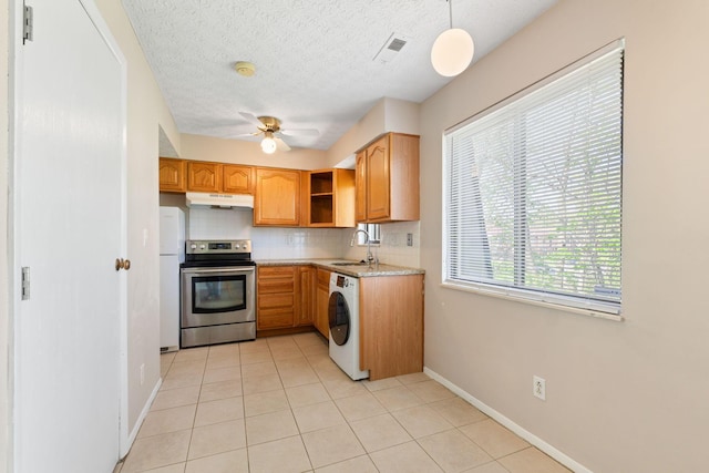 3204 Chateau Morse Ct, Columbus, OH 43231 - kitchen featuring stainless steel electric range oven, freestanding refrigerator, washer / clothes dryer, under cabinet range hood, and decorative backsplash