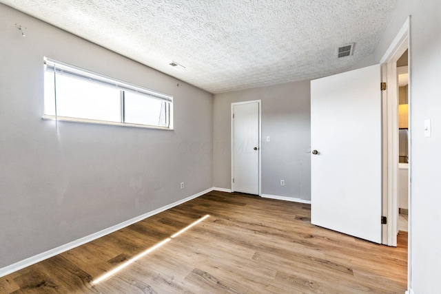 3204 Chateau Morse Ct, Columbus, OH 43231 - unfurnished bedroom featuring wood finished floors, baseboards, and a textured ceiling