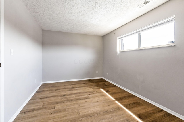 3204 Chateau Morse Ct, Columbus, OH 43231 - spare room featuring a textured ceiling, wood finished floors, and baseboards