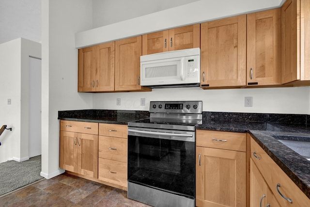 7879 Sudeley Ct, Westerville, OH 43081 - kitchen with white microwave, stainless steel range with electric stovetop, dark stone countertops, and dark carpet