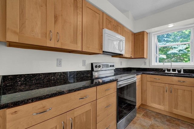 7879 Sudeley Ct, Westerville, OH 43081 - kitchen with white microwave, stainless steel range with electric cooktop, dark stone countertops, and stone finish flooring