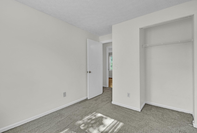 7879 Sudeley Ct, Westerville, OH 43081 - unfurnished bedroom featuring carpet flooring, a textured ceiling, and a closet