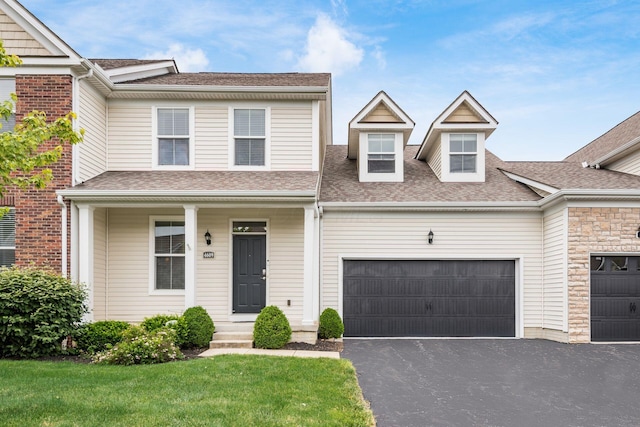 4609 Stoneworth Dr Unit 58, Hilliard, OH 43026 - view of front of house with driveway, a garage, and a shingled roof