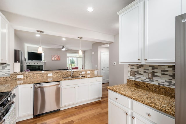 4609 Stoneworth Dr Unit 58, Hilliard, OH 43026 - kitchen with stainless steel appliances, a sink, backsplash, a ceiling fan, and light wood finished floors