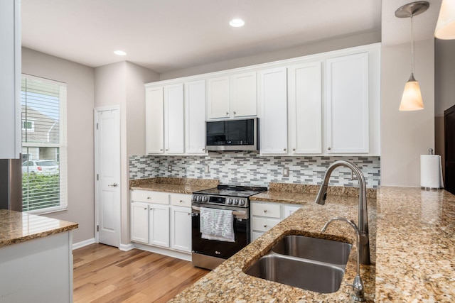 4609 Stoneworth Dr Unit 58, Hilliard, OH 43026 - kitchen with appliances with stainless steel finishes, a sink, light stone counters, white cabinets, and recessed lighting
