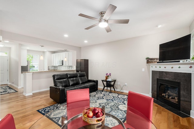 4609 Stoneworth Dr Unit 58, Hilliard, OH 43026 - living area with light wood-style floors, ceiling fan, a tile fireplace, baseboards, and recessed lighting