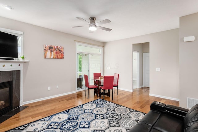 4609 Stoneworth Dr Unit 58, Hilliard, OH 43026 - living area with wood finished floors, ceiling fan, a tiled fireplace, and baseboards