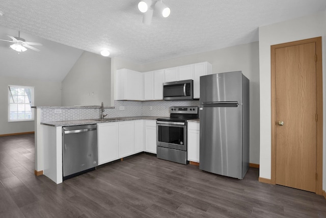 3062 Nomination Ln Unit 260, Columbus, OH 43207 - kitchen with stainless steel appliances, ceiling fan, a peninsula, white cabinetry, and decorative backsplash