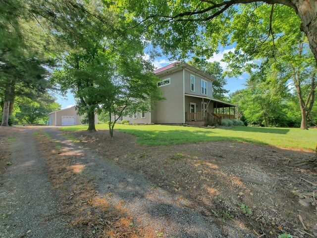 1803 County Road 26, Marengo, OH 43334 - view of property exterior featuring a porch, a garage, and a yard