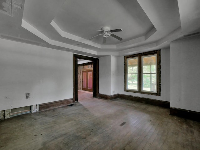 1803 County Road 26, Marengo, OH 43334 - empty room featuring a tray ceiling, a ceiling fan, and hardwood / wood-style floors