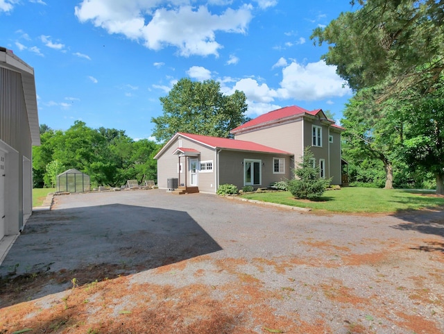 1803 County Road 26, Marengo, OH 43334 - view of side of home featuring an exterior structure, an outdoor structure, driveway, a metal roof, and a yard