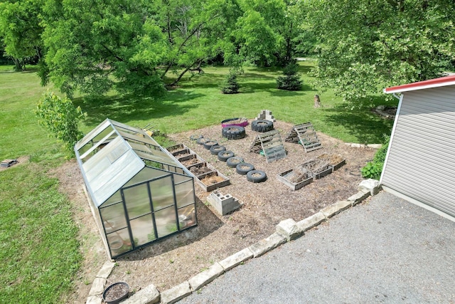 1803 County Road 26, Marengo, OH 43334 - view of green lawn featuring a greenhouse, a garden, and an outbuilding