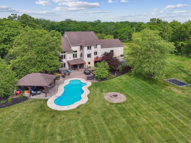 332 Waters Edge Dr, Hebron, OH 43025 - rear view of house with a gazebo, an outdoor pool, a lawn, a patio, and stucco siding