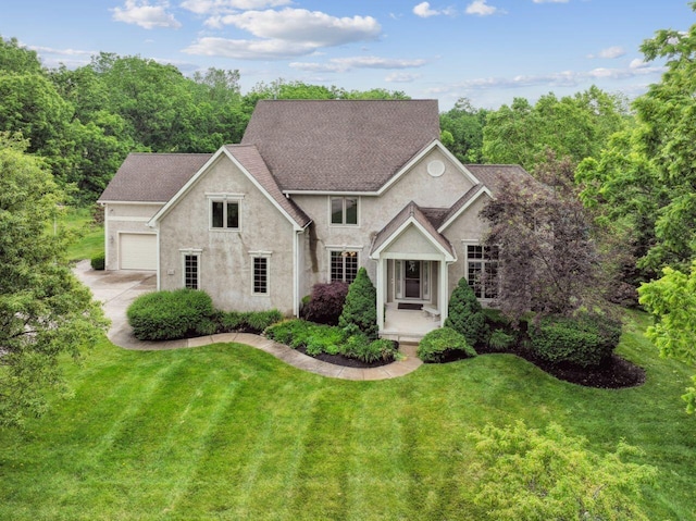 332 Waters Edge Dr, Hebron, OH 43025 - view of front of home featuring stucco siding, a front yard, an attached garage, and concrete driveway
