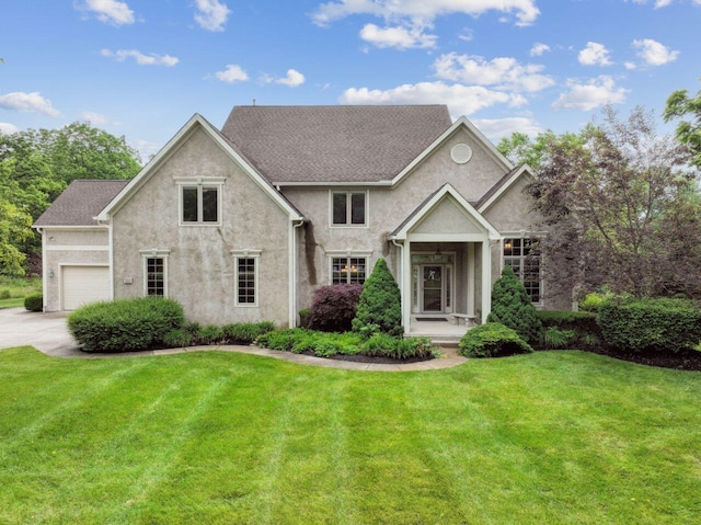 332 Waters Edge Dr, Hebron, OH 43025 - view of front facade featuring a front yard, driveway, stucco siding, and an attached garage