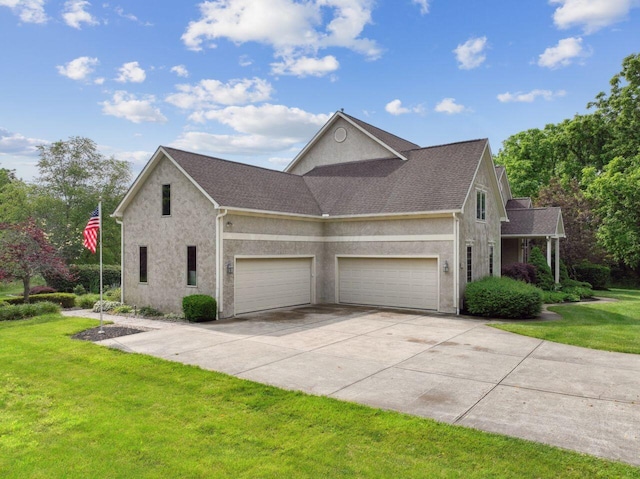 332 Waters Edge Dr, Hebron, OH 43025 - view of home's exterior featuring a lawn, a garage, stucco siding, and driveway