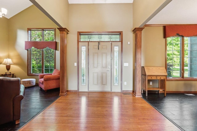 332 Waters Edge Dr, Hebron, OH 43025 - foyer entrance featuring decorative columns, high vaulted ceiling, plenty of natural light, and wood finished floors