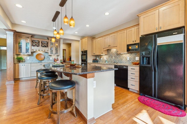 332 Waters Edge Dr, Hebron, OH 43025 - kitchen with black appliances, light brown cabinetry, decorative backsplash, a kitchen breakfast bar, and recessed lighting