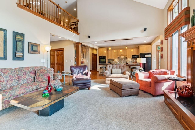 332 Waters Edge Dr, Hebron, OH 43025 - living area featuring light carpet, a towering ceiling, and ornate columns