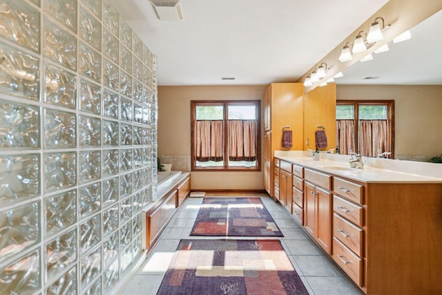 332 Waters Edge Dr, Hebron, OH 43025 - full bathroom with double vanity, healthy amount of natural light, tile patterned flooring, and a bath