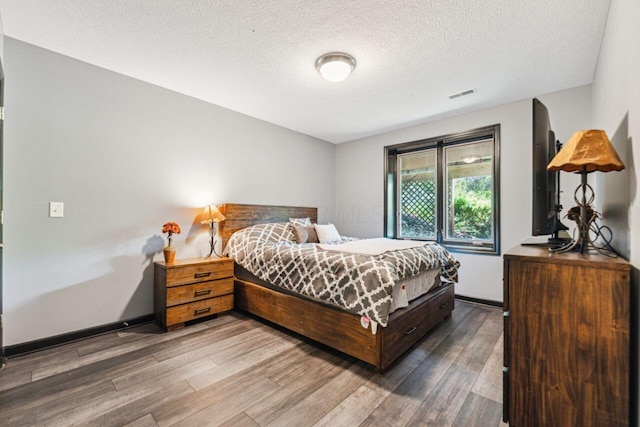 332 Waters Edge Dr, Hebron, OH 43025 - bedroom with wood finished floors and a textured ceiling