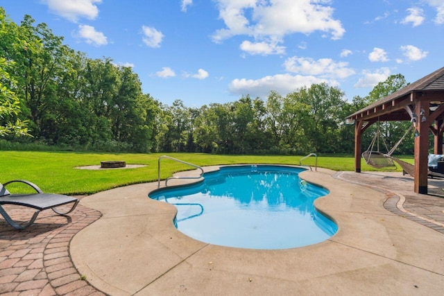 332 Waters Edge Dr, Hebron, OH 43025 - swimming pool featuring a patio area, an outdoor fire pit, a lawn, and view of wooded area