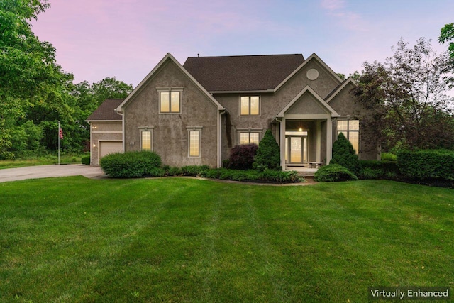 332 Waters Edge Dr, Hebron, OH 43025 - traditional-style home featuring a front lawn, concrete driveway, an attached garage, and stucco siding