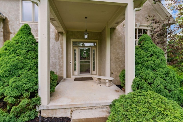 332 Waters Edge Dr, Hebron, OH 43025 - view of exterior entry with stucco siding and a porch