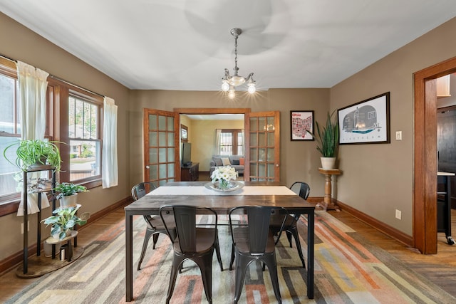 1480 Lincoln Rd, Columbus, OH 43212 - dining room featuring light wood-type flooring, a chandelier, and french doors