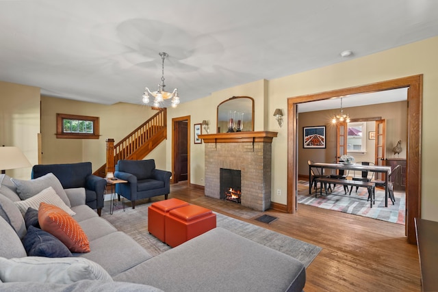 1480 Lincoln Rd, Columbus, OH 43212 - living area with stairway, a chandelier, wood finished floors, and a fireplace