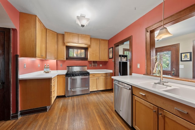 1480 Lincoln Rd, Columbus, OH 43212 - kitchen featuring stainless steel appliances, wood finished floors, light countertops, and decorative light fixtures