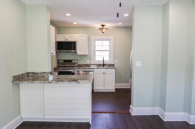 214 Moull St, Newark, OH 43055 - kitchen with stainless steel appliances, light stone countertops, white cabinetry, dark wood-type flooring, and recessed lighting