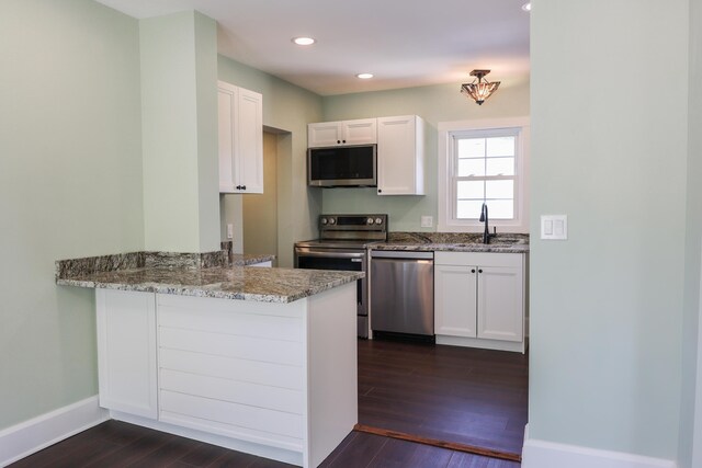 214 Moull St, Newark, OH 43055 - kitchen featuring stainless steel appliances, dark wood-style flooring, light stone counters, white cabinets, and recessed lighting