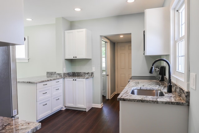 214 Moull St, Newark, OH 43055 - kitchen with dark wood-type flooring, light stone countertops, white cabinetry, healthy amount of natural light, and recessed lighting